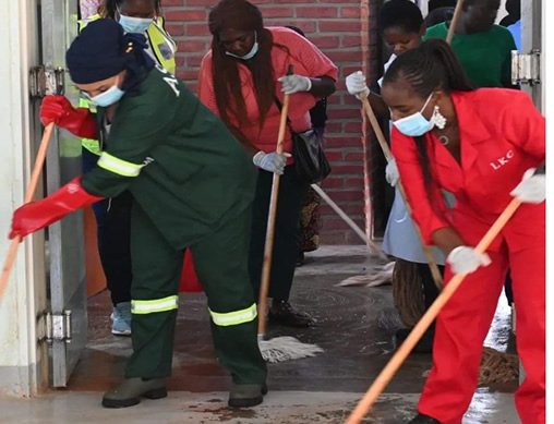 Minister and Deputy Minister of Water and Sanitation taking a part in mopping and cleaning floors for a cleaner environment at Area 25 Health Centre Image